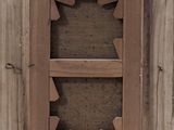 a picture of a wooden window with a hole in it