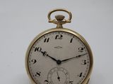 a small gold pocket watch with a chain around it