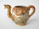 an image of a ceramic teapot with a dragon handle
