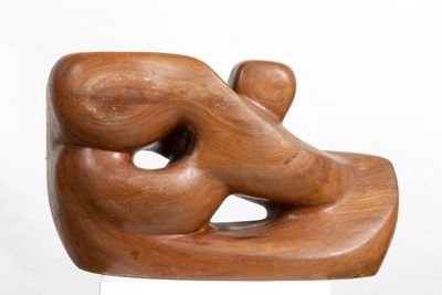 wooden sculpture of a man and a woman holding each other ' s hands