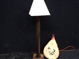a lamp that is sitting next to a rock