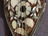 a close up of a guitar that is on a table