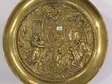 gold plate with an image of a man and woman in a garden