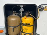 two propane gas cylinders in the back of a camper
