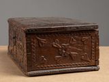 an old wooden box sitting on top of a table next to a wall