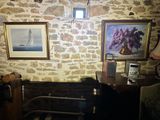 a picture of a room with a bed and pictures on the wall