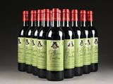 six bottles of red wine lined up in a row on a table