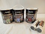 three cans of paint and two cans of paint sitting on a white surface