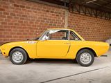 a yellow car that is parked in a garage
