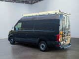 an image of a black van parked in a large room