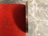 a pair of scissors that are on a red cloth