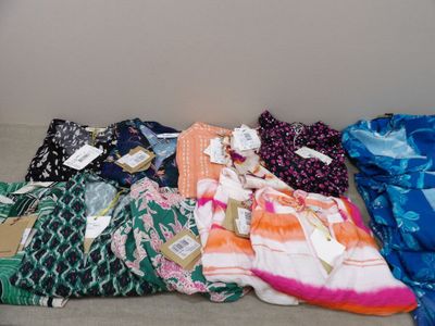 many different types of clothing laid out on the floor