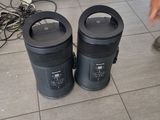 two trash cans sitting on the floor next to each other