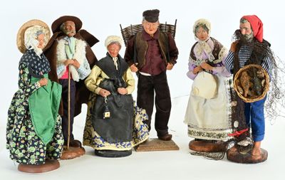 five figurines of people dressed in traditional clothing