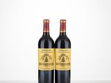 two bottles of wine sitting on top of a table next to each other