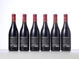 six bottles of red wine lined up in a row