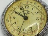 a silver pocket watch with a chain around it