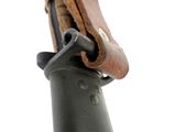 a close up of a leather bag on top of a metal pole