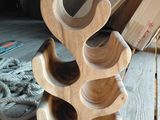 a wooden wine rack that is on a wooden table