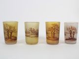 three shot glasses with a picture of a landscape on them
