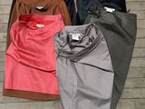 three pairs of women ' s pants are lined up on a wooden floor