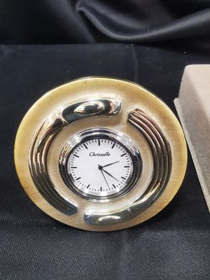 a clock that is sitting on a table next to a box