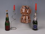 a bottle of champagne and a bottle of wine next to a candelab