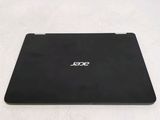the back of a black laptop computer sitting on top of a white surface