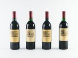 three bottles of wine are lined up on a white surface