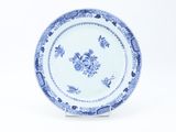 a blue and white plate with a floral design on it