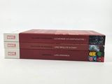 three books are stacked on top of each other on a white surface