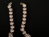 a pair of goldtone and crystal earrings
