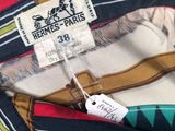 striped shirt with a tag on it sitting on a blue surface