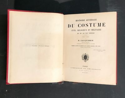 an open book sitting on top of a table next to a black table