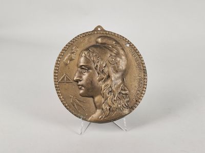 a gold coin with a woman ' s face on it