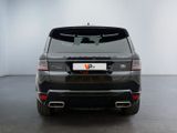 the rear end of a black range rover parked in a white room