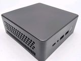 a close up of a small black computer on a white surface