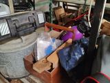 a pile of luggage sitting on a pallet in a garage