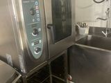 a commercial kitchen with two ovens and a sink