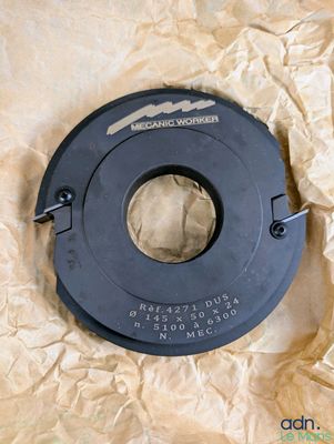 a close up of a black circular object on a piece of paper