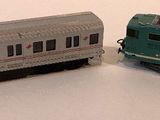 two toy trains sitting next to each other on a table