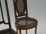 three antique wooden chairs with cane back and cane legs