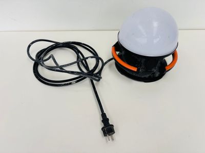 a close up of a lamp on a table with a cord