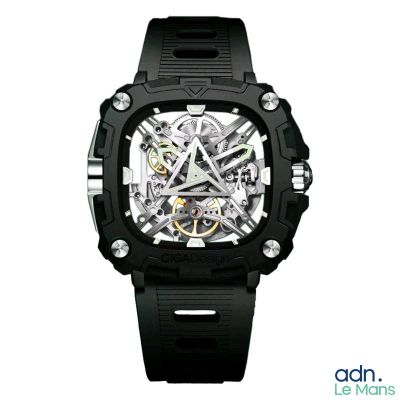 une photo d'une montre noire avec un cadran squelette