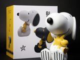 peanuts snoop and woodstock figurine in a box with a black and white background