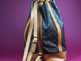 a picture of a louis vuitton bag on a purple background