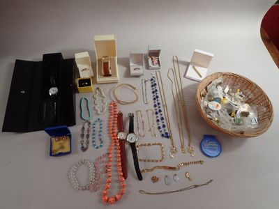 a table with a basket of jewelry on it