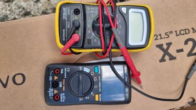two multimeters that are sitting on a box