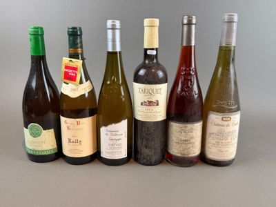several bottles of wine are lined up in a row on a table