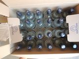 many bottles of water in a box on the floor